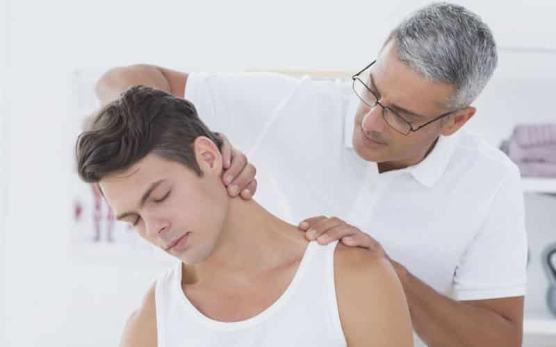 chiro doing neck adjustment on young man
