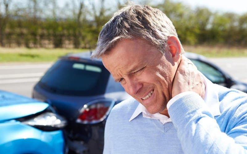 man holding neck with whiplash