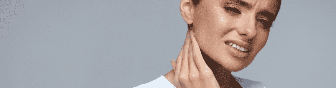 A woman touching her jaw in pain