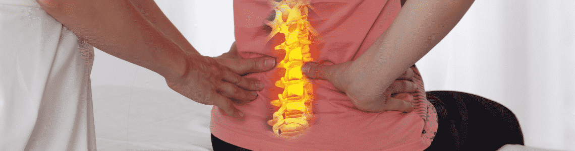 woman getting back adjusted while sitting with yellow back diagram showing spine