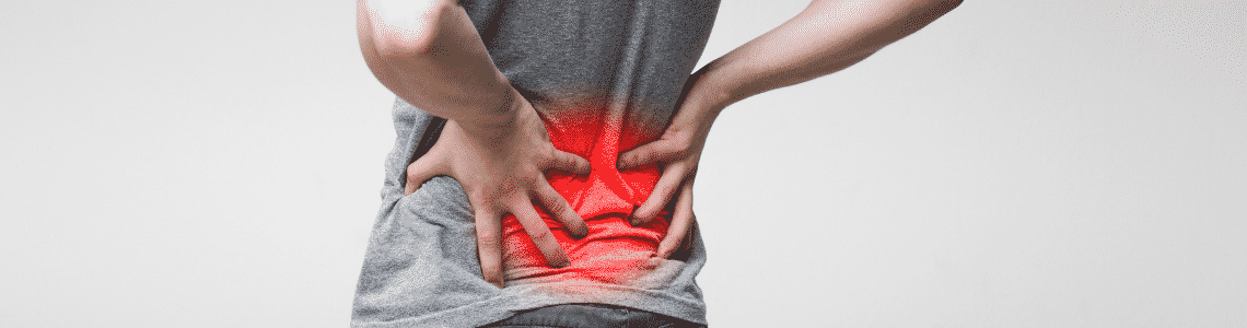 person holding lower back in pain