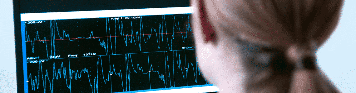 woman looking at line graph readings