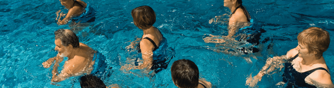 A group of adults excercising in a pool 