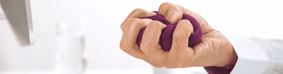 A hand squeezing a stress ball