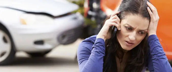woman on phone after auto accident