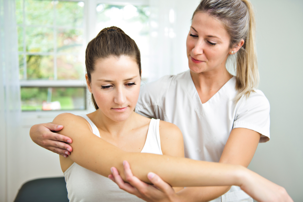 A Modern rehabilitation physiotherapist at work with client